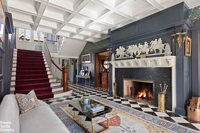 1305 Albemarle Rd, New York City, NY 11226 - living room with a fireplace with flush hearth, stairs, beam ceiling, coffered ceiling, and wallpapered walls