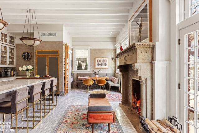 1305 Albemarle Rd, New York City, NY 11226 - living area featuring healthy amount of natural light, a warm lit fireplace, and wood finished floors