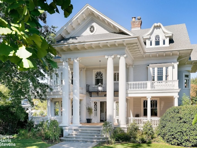 1305 Albemarle Rd, New York City, NY 11226 - greek revival house featuring a balcony, covered porch, and a chimney