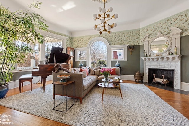 1305 Albemarle Rd, New York City, NY 11226 - living area with a chandelier, wood finished floors, a brick fireplace, baseboards, and wallpapered walls