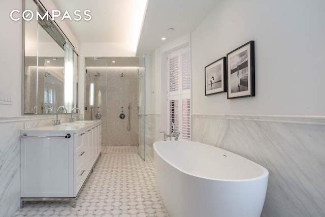 182 W 82nd St Unit 4E, New York City, NY 10024 - full bath featuring a tile shower, a soaking tub, double vanity, tile walls, and healthy amount of natural light