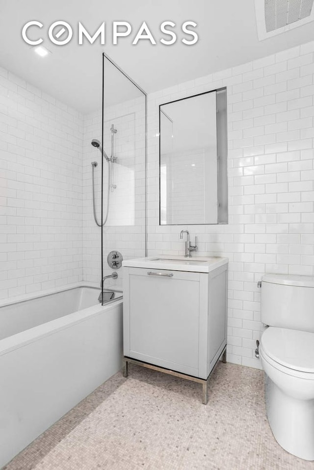 182 W 82nd St Unit 4E, New York City, NY 10024 - bathroom featuring vanity, bathtub / shower combination, toilet, and tile walls
