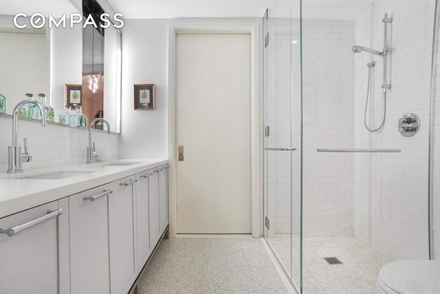 182 W 82nd St Unit 4E, New York City, NY 10024 - bathroom with a stall shower, double vanity, and tasteful backsplash