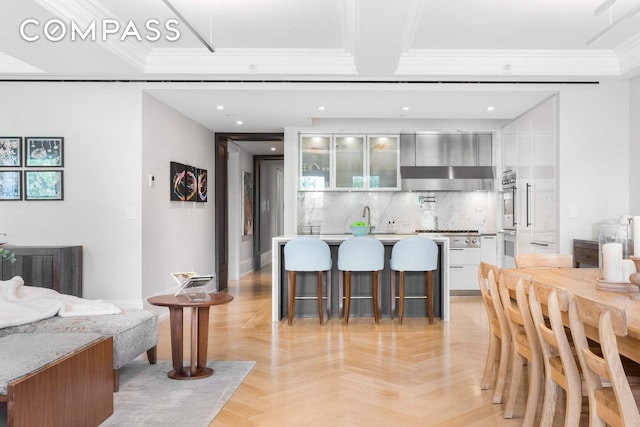 182 W 82nd St Unit 4E, New York City, NY 10024 - dining space with bar with sink, ornamental molding, and recessed lighting