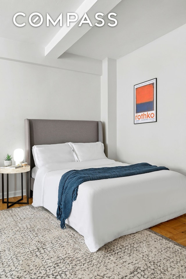 bedroom with baseboards and wood finished floors