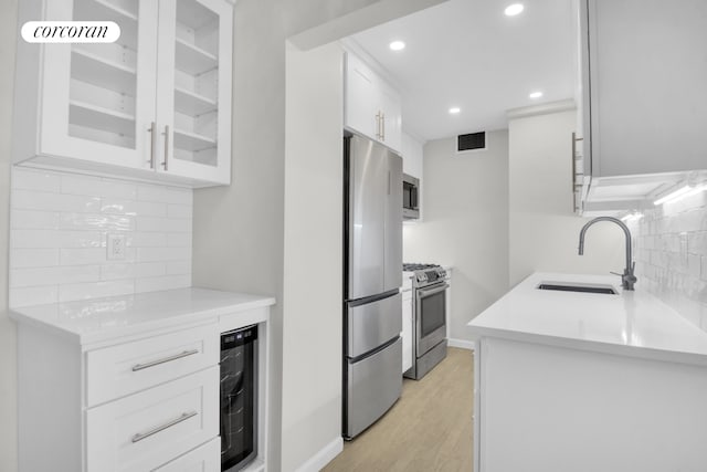 205 3rd Ave Unit 2V, New York City, NY 10003 - kitchen with a sink, wine cooler, stainless steel appliances, tasteful backsplash, and recessed lighting
