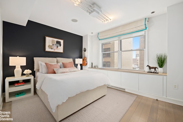 595 W End Ave Unit 9Fl, New York City, NY 10024 - bedroom featuring an accent wall, light wood finished floors, and recessed lighting