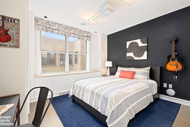 595 W End Ave Unit 9Fl, New York City, NY 10024 - bedroom with wood finished floors and an accent wall
