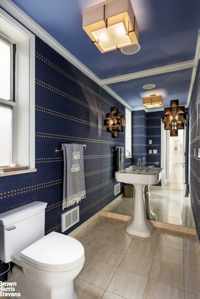 bathroom featuring a chandelier, toilet, and tile patterned floors