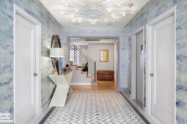 corridor with a chandelier, stairs, tile patterned floors, and baseboards
