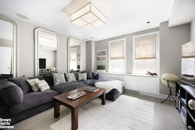 living area with healthy amount of natural light and wood finished floors