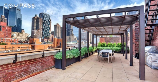 view of patio / terrace featuring a skyline view, a pergola, outdoor dining area, and a grill