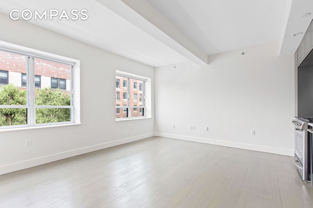432 W 52nd St Unit 4H, New York City, NY 10019 - unfurnished living room with wood finished floors and baseboards