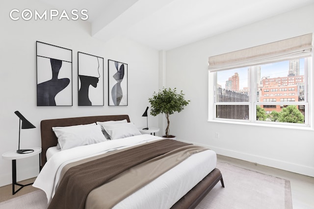 432 W 52nd St Unit 4H, New York City, NY 10019 - bedroom with a city view, beamed ceiling, and wood finished floors