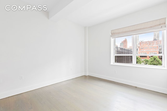 432 W 52nd St Unit 4H, New York City, NY 10019 - spare room with wood finished floors and a city view