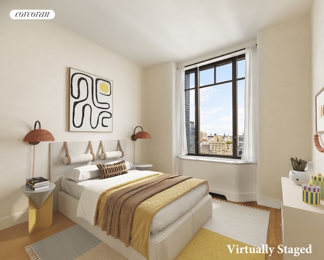 bedroom featuring wood finished floors and baseboards