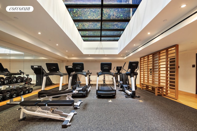 workout area featuring recessed lighting and a high ceiling
