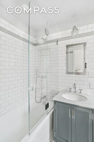 350 E 57th St Unit 14B, New York City, NY 10022 - full bath with combined bath / shower with glass door and vanity
