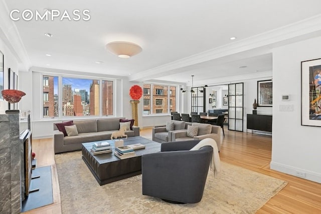 350 E 57th St Unit 14B, New York City, NY 10022 - living area with ornamental molding, light wood-style flooring, and baseboards
