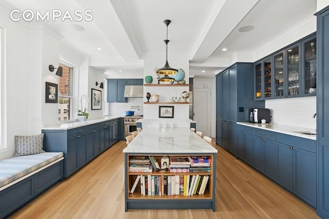 350 E 57th St Unit 14B, New York City, NY 10022 - kitchen featuring open shelves, blue cabinetry, under cabinet range hood, backsplash, and beamed ceiling