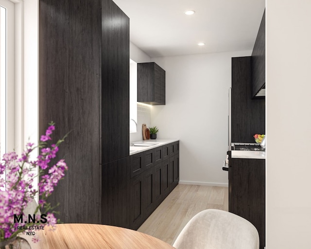102-10 Queens Blvd Unit 701, New York City, NY 11375 - kitchen featuring light wood-type flooring, light countertops, a sink, dark cabinets, and recessed lighting