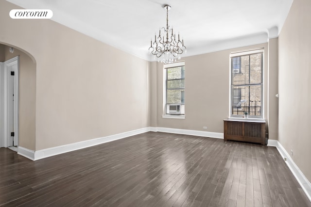 318 W 100th St Unit 1D, New York City, NY 10025 - empty room with arched walkways, dark wood finished floors, and baseboards