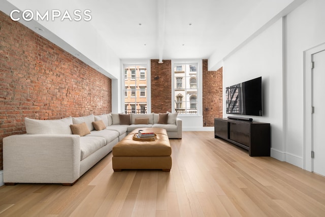 51 Warren St Unit 3W, New York City, NY 10007 - living area with brick wall and light wood finished floors