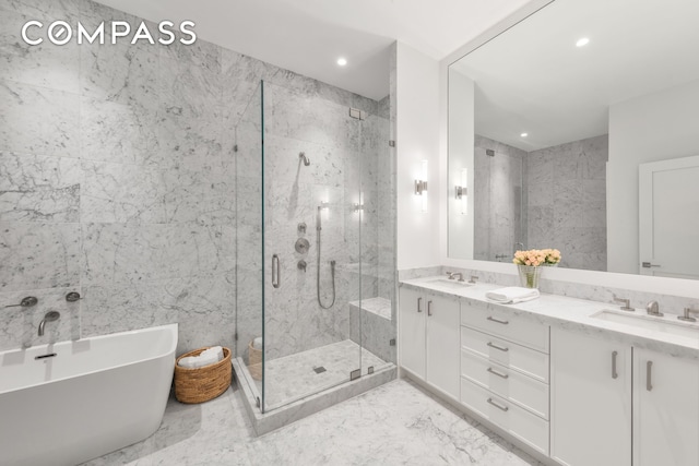 51 Warren St Unit 3W, New York City, NY 10007 - full bathroom featuring a marble finish shower, a soaking tub, double vanity, marble finish floors, and recessed lighting