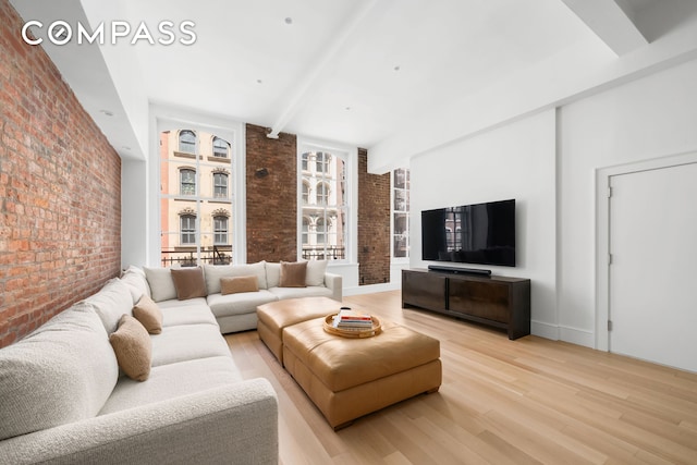 51 Warren St Unit 3W, New York City, NY 10007 - living room with brick wall, beamed ceiling, and light wood-style flooring