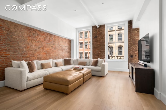 51 Warren St Unit 3W, New York City, NY 10007 - living area featuring brick wall, beamed ceiling, light wood-type flooring, and baseboards