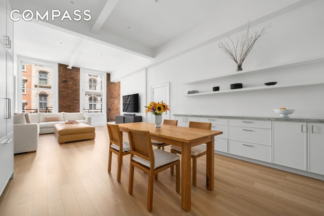 51 Warren St Unit 3W, New York City, NY 10007 - dining space featuring beamed ceiling, light wood-type flooring, and brick wall