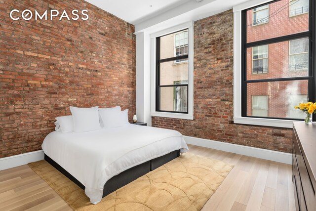 51 Warren St Unit 3W, New York City, NY 10007 - bedroom with brick wall and wood finished floors