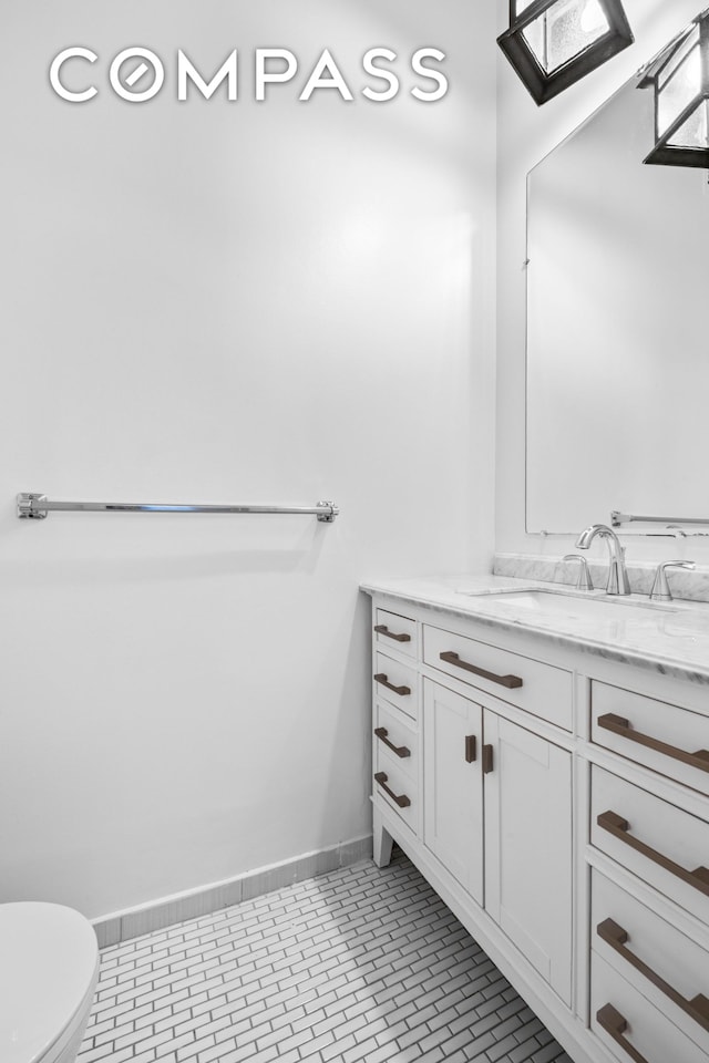 448 W 37th St Unit 6H, New York City, NY 10018 - half bath with vanity, toilet, tile patterned flooring, and baseboards