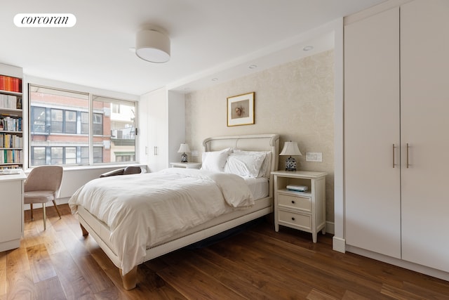 bedroom featuring dark wood-style floors and baseboards