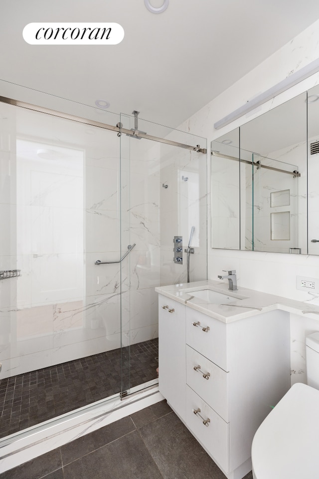 bathroom with a marble finish shower, toilet, and vanity