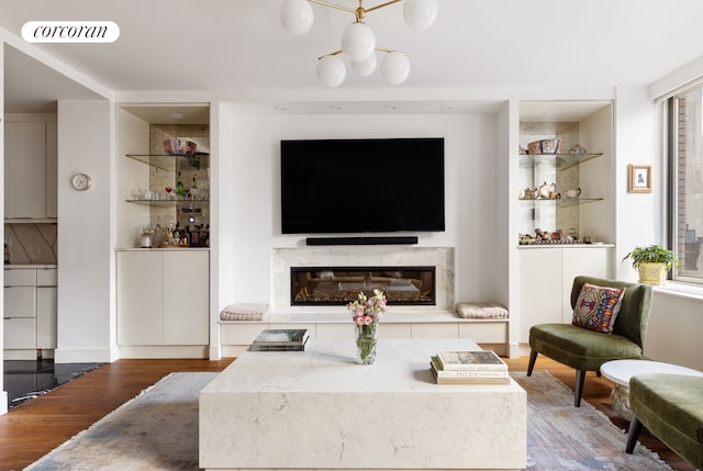 living room with wood finished floors and a premium fireplace