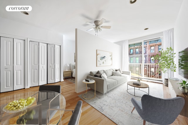 living room featuring a ceiling fan and wood finished floors