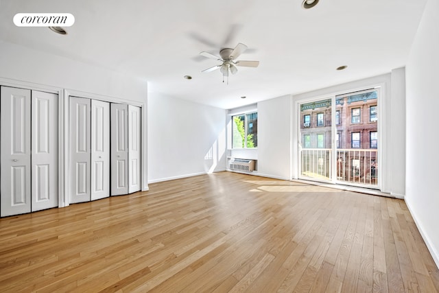 unfurnished living room with a ceiling fan, light wood finished floors, and baseboards