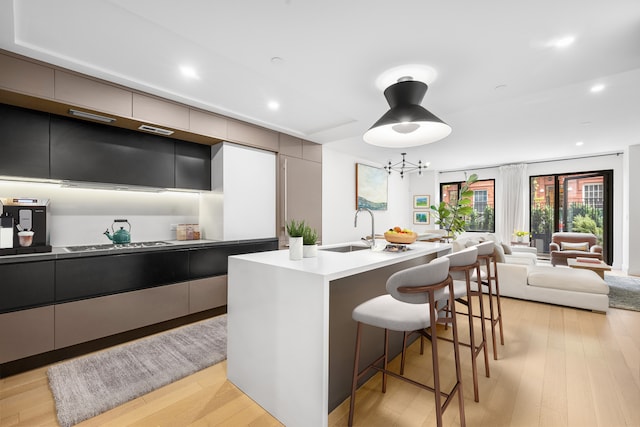 318 E 81st St Unit 1, New York City, NY 10028 - kitchen featuring a sink, a breakfast bar, modern cabinets, and recessed lighting