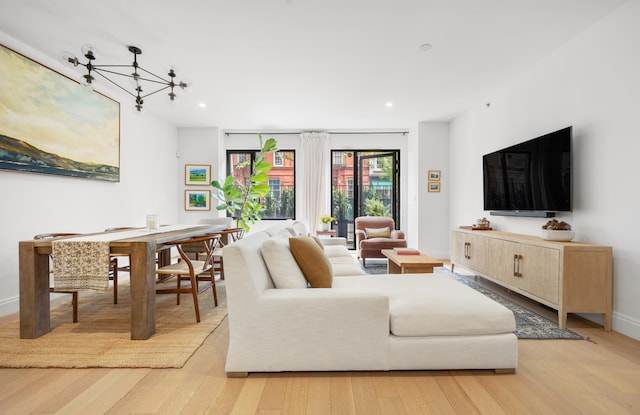 318 E 81st St Unit 1, New York City, NY 10028 - living room with a chandelier, light wood finished floors, recessed lighting, and baseboards