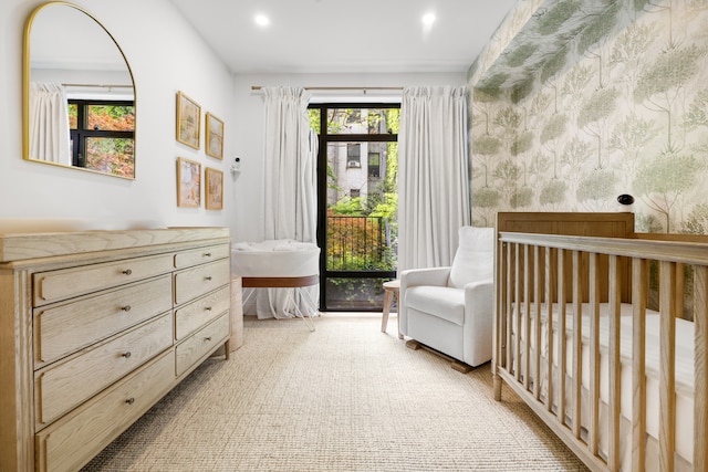 318 E 81st St Unit 1, New York City, NY 10028 - bedroom featuring wallpapered walls, recessed lighting, and a nursery area