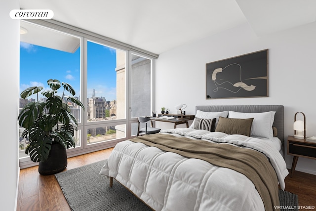 340 E 23rd St Unit Ph2F, New York City, NY 10010 - bedroom with wood finished floors, floor to ceiling windows, and a view of skyline