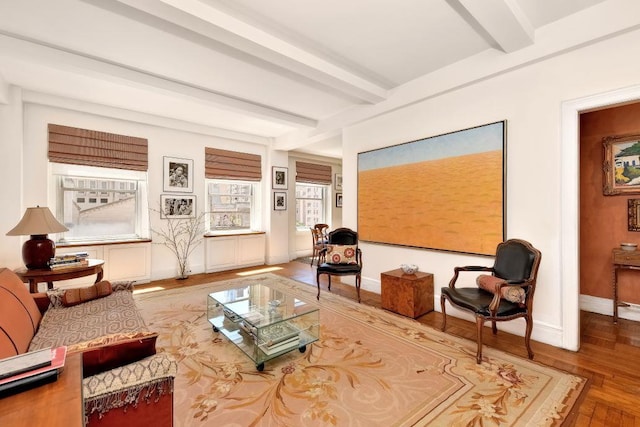 67 Park Ave Unit 6-C, New York City, NY 10016 - living area featuring beamed ceiling, baseboards, and wood finished floors