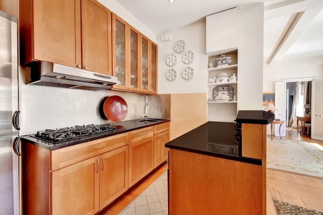 67 Park Ave Unit 6-C, New York City, NY 10016 - kitchen with under cabinet range hood, black gas cooktop, dark countertops, a sink, and open shelves