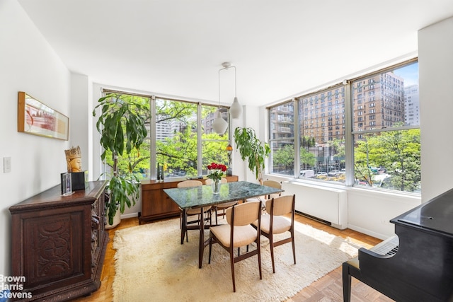 dining area with a city view and baseboards
