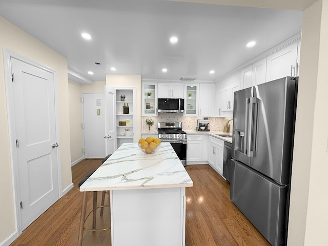 12-06 Robin Ln Unit 1028, New York City, NY 11360 - kitchen featuring stainless steel appliances, a center island, dark wood finished floors, white cabinetry, and tasteful backsplash