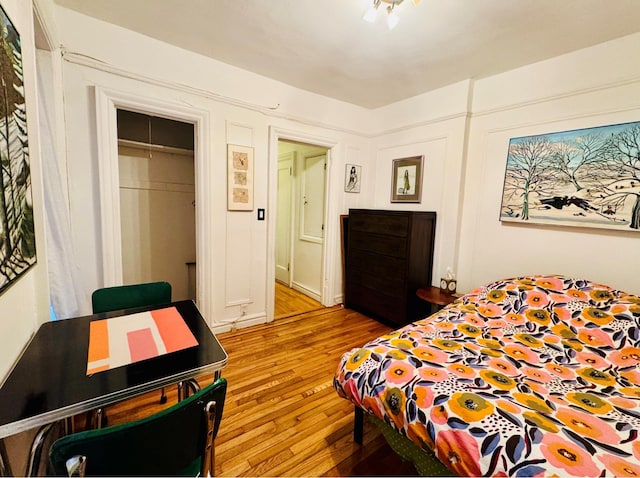 bedroom featuring light wood-type flooring and a closet