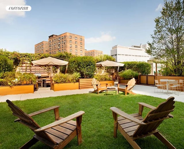view of community featuring a yard and a patio area