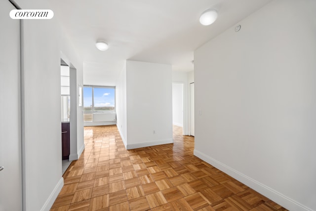 hallway featuring baseboards