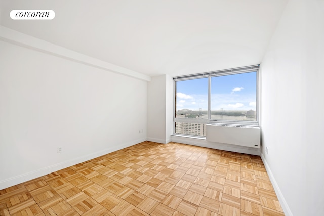 unfurnished room featuring baseboards
